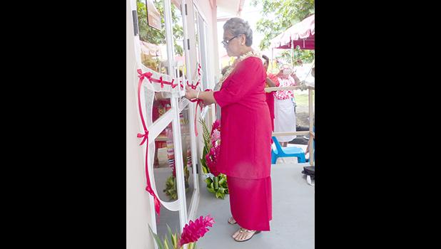 First lady Cynthia Malala Moliga cuts the ribbon during yesterday’s official dedication and opening of the new building in Tafuna for the Red Cross of American Samoa. See story inside. [photo: Leua Aiono Frost]