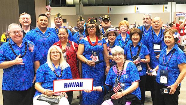 Igafo Maria Brown Va’a (middle holding US flag with red lei) along with the Hawaii Veterans of Foreign War delegation