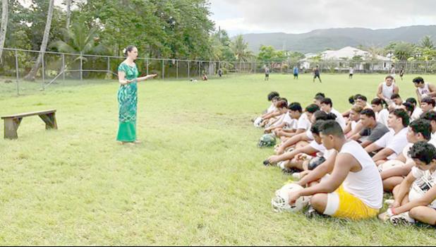 Marian McGuire Ale speaking to Leone football players 