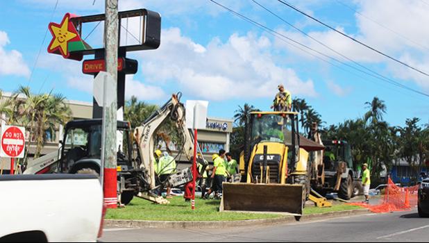 Heavy equipment removing bus stop in front of Laufou 