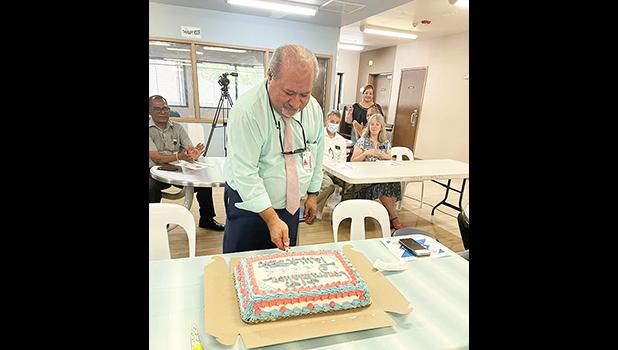 CEO Moefa'auo William Emmsley cuts cake