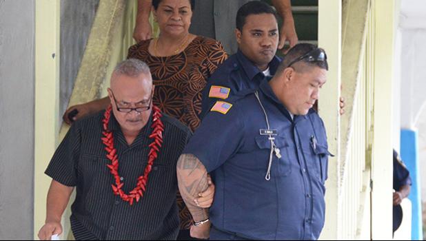 Deputy Commissioner Falana’ipupu Ta’ase Sagapolupele (left) and two other police officers escorting Police Officer Fa’auma Malo (right) after his arrest in 2017