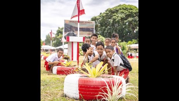 children looking at fala plant