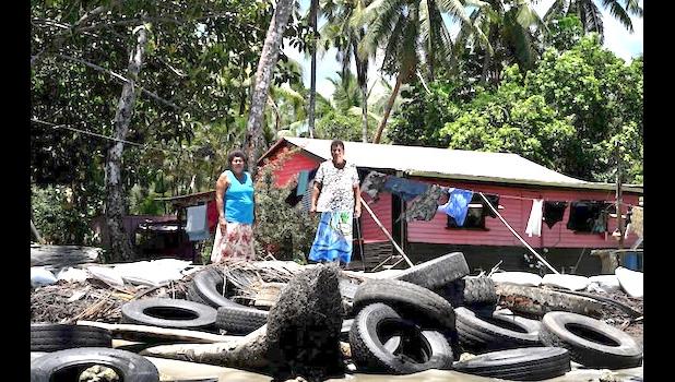 trying to save their home with old tires to block erosion