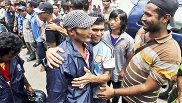 In this Sept. 8, 2015 photo, a Burmese fisherman, center, is embraced by a friend as he leaves the port town of Ambon, Maluku province, Indonesia. More than 2,000 fishermen have been rescued this year from brutal conditions at sea, their freedom prompted by an Associated Press investigation into seafood brought to the U.S. from a slave island in eastern Indonesia. Dozens of Burmese men in the bustling port town of Ambon were the latest to go home, some more than a decade after being trafficked onto Thai trawlers. (AP Photo/Achmad Ibrahim) In this Sept. 8, 2015 photo, a Burmese fisherman, center, is embraced by a friend as he leaves the port town of Ambon, Maluku province, Indonesia. More than 2,000 fishermen have been rescued this year from brutal conditions at sea, their freedom prompted by an Associated Press investigation into seafood brought to the U.S. from a slave island in eastern Indonesia. Dozens of Burmese men in the bustling port town of Ambon were the latest to go home, some more than a decade after being trafficked onto Thai tra