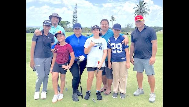 Front row, from left: Kendall Fe‘a, Tusi Vaouli, golfer mom La Poasa with her niece Char and daughter Daenerys Vitolio, and Sai Vaouli, Tusi’s father. Back row: Niko Fe‘a, Kendall’s father, and junior golf coach John Mitchell. Junior golfers with parents and coaches
