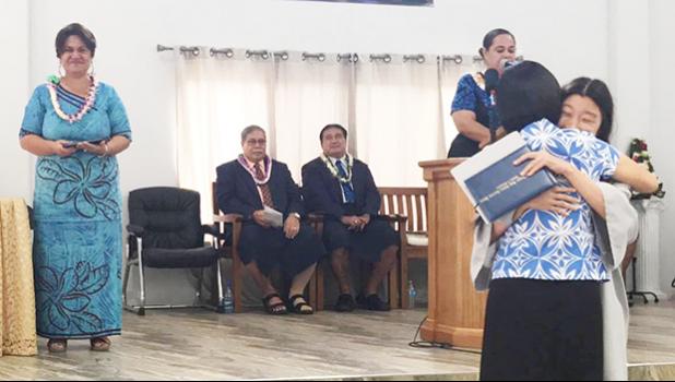 Manumalo Academy’s Class of 2017 valedictorian Alice Park hugging her mom after receiving her diploma last Friday morning, while DOE Director Dr. Ruth Matagi-Tofiga, Pastor Filifaatali Mike Fuiava, and Paster Lemmy Seumanu look on. [photo: BC]
