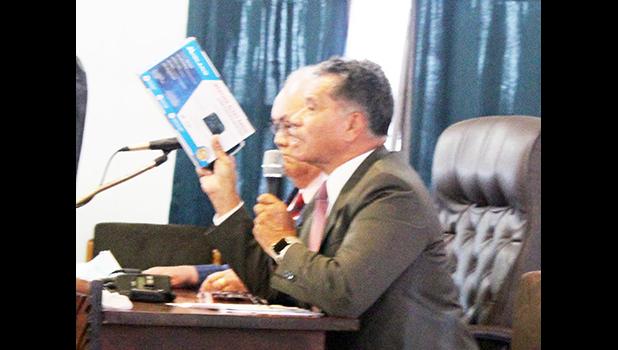  Samana Semo Ve’ave’a holds up for visual display the NOAA weather radio,