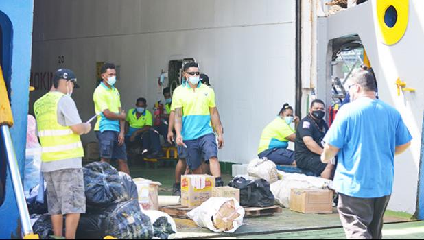 Bags of taro being unloaded at wharf.