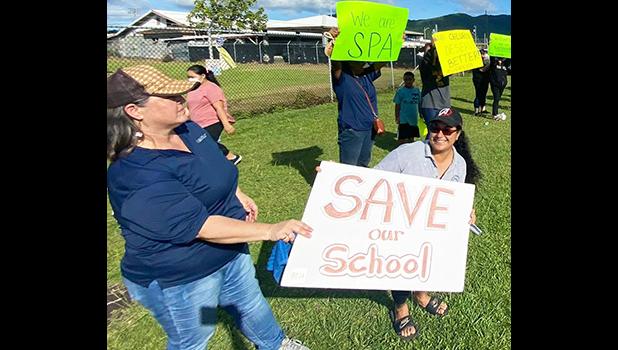 Teachers and demonstrators last week hold signs at SPA