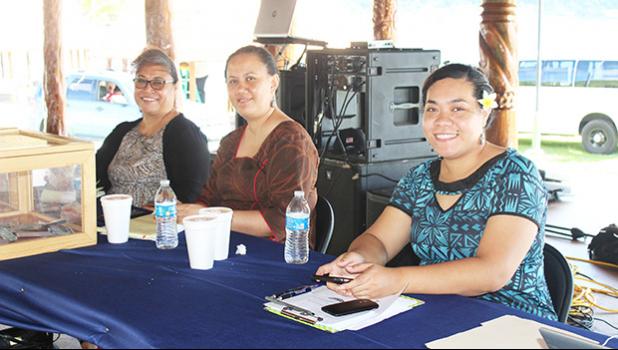 A trio of ASG personnel posing for a Samoa News photo at first day of fundraising