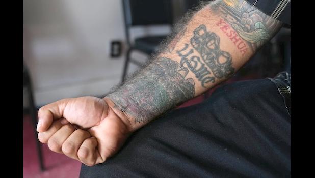 Julio Torre shows his USMC tattoo