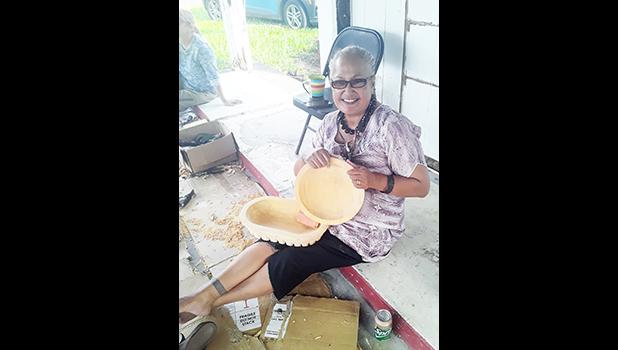 Andre Samoa with her kava bowls she carved