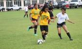Ama Faleao of Leone tries to dribble away from Maricar Parungo of the Fa’asao Cougars during an ASHSAA varsity girls’ soccer game on Saturday, Feb. 24, 2018 at Pago Park Soccer Stadium.  [FFAS MEDIA/Brian Vitolio]