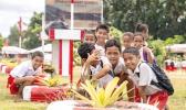 children looking at fala plant