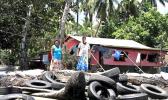 trying to save their home with old tires to block erosion