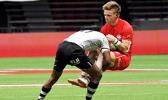 Canada’s Luke McCloskey is pummeled by Fiji’s Aminiasi Tuimaba