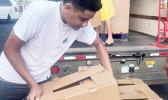 Ā’oga Samoa boys unloading cartons of food