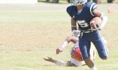 Samoana Sharks Sophomore at running back, Marcus Samia beating a Tafuna defender