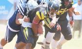 Joe Savaii trying to escape the grasp of a Samoana defender 
