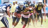 Samoana Sharks quarterback Viliamu Tanielu stiff arms a Nu’uuli Wildcat defender 