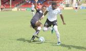 Milo Tiatia (left) of American Samoa battles for possession