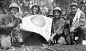 Trophy: U.S. troops hold a Japanese flag captured in July 1944 during the Battle of Saipan