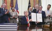 US President Donald Trump displays a proclamation 