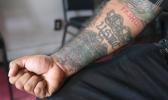 Julio Torre shows his USMC tattoo