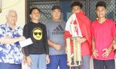 Members of the Vaiala Tongan Boys 13-15 team receive their championship trophy